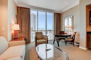 a living room with a couch and a table at MGM Studio Suite with POOL VIEW Tower 1 in Las Vegas