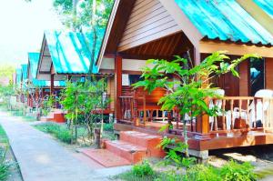 a house with a porch and stairs to it at Sayang Beach Resort Koh Lanta in Ko Lanta