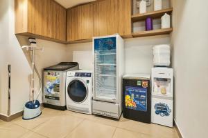 a laundry room with a washing machine and a washer at MIHN SUITES BEN THANH in Ho Chi Minh City