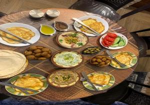 a table filled with plates of food on a table at kirakoupolis House & Restaurant in Kerak