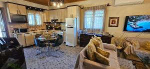 a kitchen with a refrigerator and a table in a room at Ryan's house in Vergia