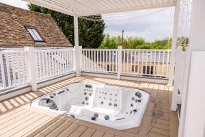 a hot tub on the deck of a house at The Manor at Minstrel Court with Hot Tub in Cambridge