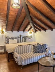a living room with a bed and a couch at ClubOrsa Ourania's Mansion in Skiathos