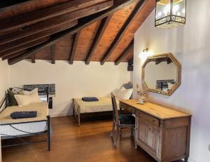 1 dormitorio con escritorio, 1 cama y espejo en ClubOrsa Ourania's Mansion, en Skiathos