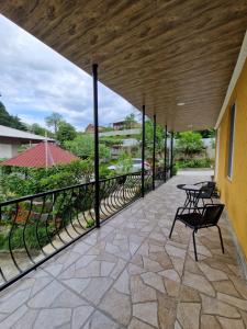 a balcony with a black railing and a table at Magdan house in Tsqaltubo +83 photos