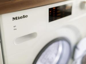 a close up of a washing machine with a clock at Norda - Langeoog Comfortable holiday residence in Langeoog