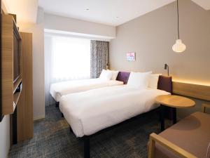 GRIDS PREMIUM HOTEL OTARU客房内的一张或多张床位