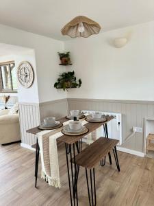 a dining room with a table and chairs at Kennel House with Hill Views in Whitland