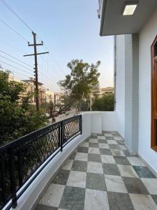 a balcony of a house with a checkered floor at Luxury duplex bungalow noida 50 in Noida