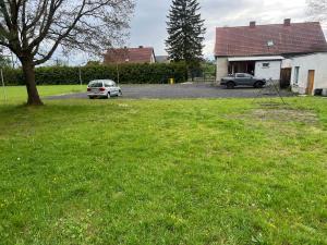a car parked in a parking lot next to a house at Pokoje na wsi in Bukowina