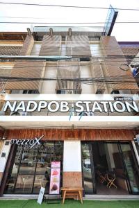 a store with a sign on the front of a building at NADPOB Station นัดพบสเตชั่น in Ban Tha Kham