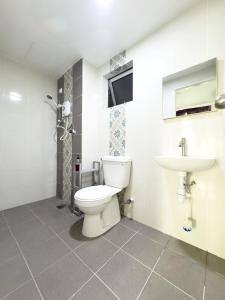 a bathroom with a toilet and a sink at A Room - Stay With the Host in Ipoh