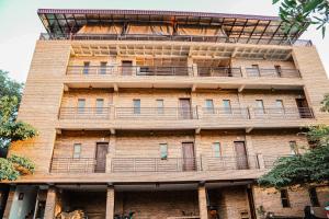 a tall brick building with balconies on it at Bamboo Bungalow in Kampot