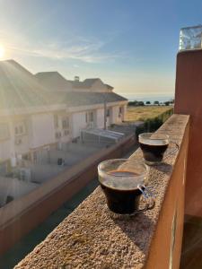 two bowls on a ledge with a view of a building at Nice 3 bedroom Duplex Cabo Roig in Orihuela Costa
