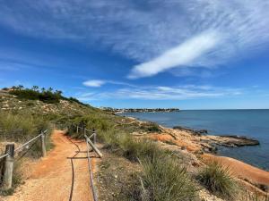 a path on a hill next to the ocean at Nice 3 bedroom Duplex Cabo Roig in Orihuela Costa