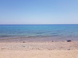 a sandy beach with the ocean in the background at New Mabroka in Nuweiba