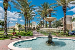 a fountain in a park with palm trees at Upscale 3BR Condo - Family Resort - Pool And Hot Tub! in Orlando