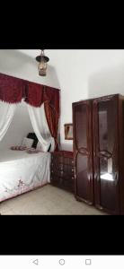 a bedroom with a bed and a dresser at Dar manena in Kairouan