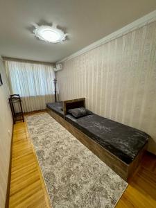 a bedroom with a bed in the corner of a room at Classic C1 Apartment In The Center With 4 Rooms in Tashkent +26 photos