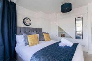 ein Schlafzimmer mit einem großen Bett mit einer Uhr an der Wand in der Unterkunft Fantastic Four Bed Two Bath Home 