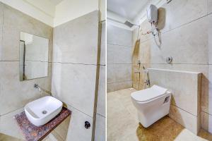 a bathroom with a toilet and a sink at FabHotel HK Villa in Vadodara