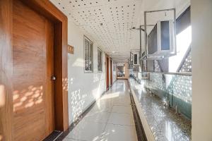 a hallway of a building with a pool of water at FabHotel HK Villa in Vadodara
