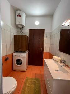 a bathroom with a washing machine and a washer at Family View in Sarandë
