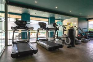a gym with three tread machines in a room at OCEANA HOME Phuket Kamala in Phuket Town