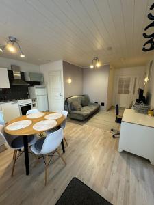a kitchen and living room with a table and chairs at Luonto Lähellä Residence in Vantaa +5 photos