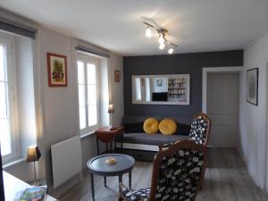 a living room with a couch and a table at Location Ker Bihan in Saint-Lunaire