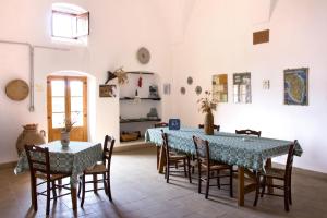 a dining room with a blue table and chairs at Terra di Leuca in Salve +69 photos