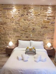 a bedroom with a large white bed with two pillows at CityZen Rooms Chios in Chios