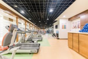 a gym with treadmills and elliptical machines at Oakwood Residence Shanghai in Shanghai