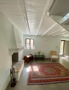 a living room with a couch and a rug at The Bellhouse Kranidi in Kranidi