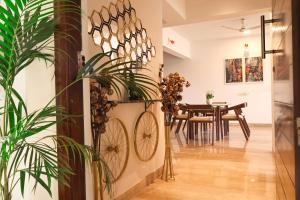 a dining room with a table and a bike on the wall at Stylish 3BHK Penthouse W/Terrace Steps from EON IT in Pune