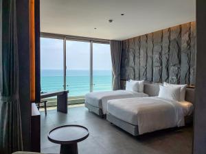 Ένα ή περισσότερα κρεβάτια σε δωμάτιο στο M Hotel Danang