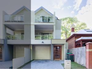 a white house with a garage in front of it at Executive CBD Perth House 4BR 3BA 2Pk SLEEP 8! in Perth