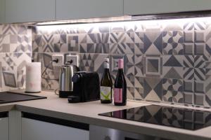 two bottles of wine sitting on a kitchen counter at Cairoli Lifestyle in Fano