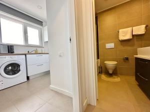 a bathroom with a washing machine and a toilet at Double Studio B601 StayInn by Cosmopolis in Ştefăneştii de Jos +11 photos