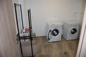 two washing machines and a washer and dryer in a room at AKAMAS THRONE APARTMENTS in Neo Chorio