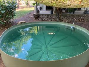 a jacuzzi tub in a yard with at Quiet Rural Retreat in Howard Springs