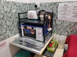 a small kitchen with a microwave on a counter at Sunway Paradise Home Staycation PH2100 SELF CHECK IN OUT in Subang Jaya