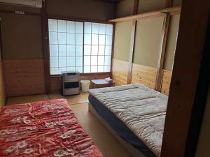 Postel nebo postele na pokoji v ubytování Futago Cabin