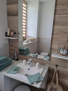 a bathroom with a sink and a mirror at chez céline in Sens-de-Bretagne
