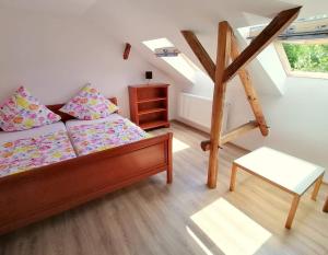 a room with a bed and a table and a window at Casa Bunicii in Sasca Montană