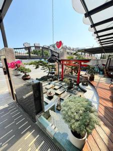 a patio with potted plants on a wooden deck at Circle B&B in Jian