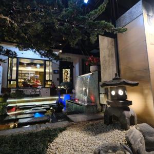a japanese garden with a shrine and a restaurant at Circle B&B in Jian
