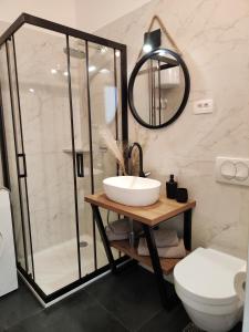 a bathroom with a sink and a shower and a toilet at King's Apartment in Baška +20 photos