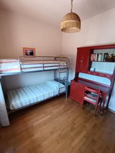 a room with two bunk beds and a desk at Ornella's apartment in Casale di Scodosia