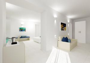 a white living room with a couch and a table at Amalfi Suite Boutique Hotel in Amalfi